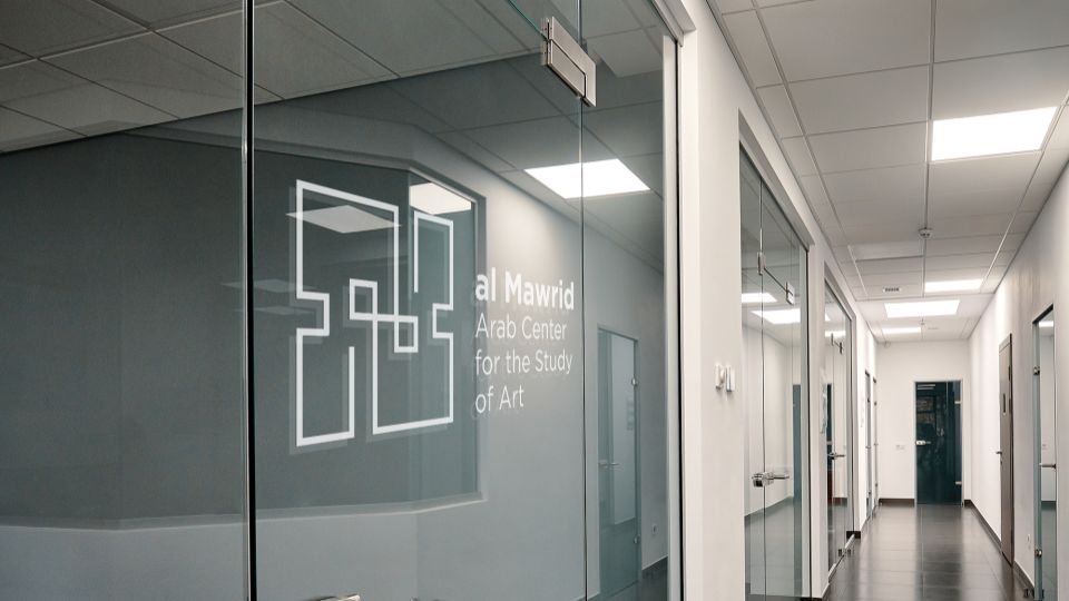 Mockup of an office hallway glass door with the proposed logo.