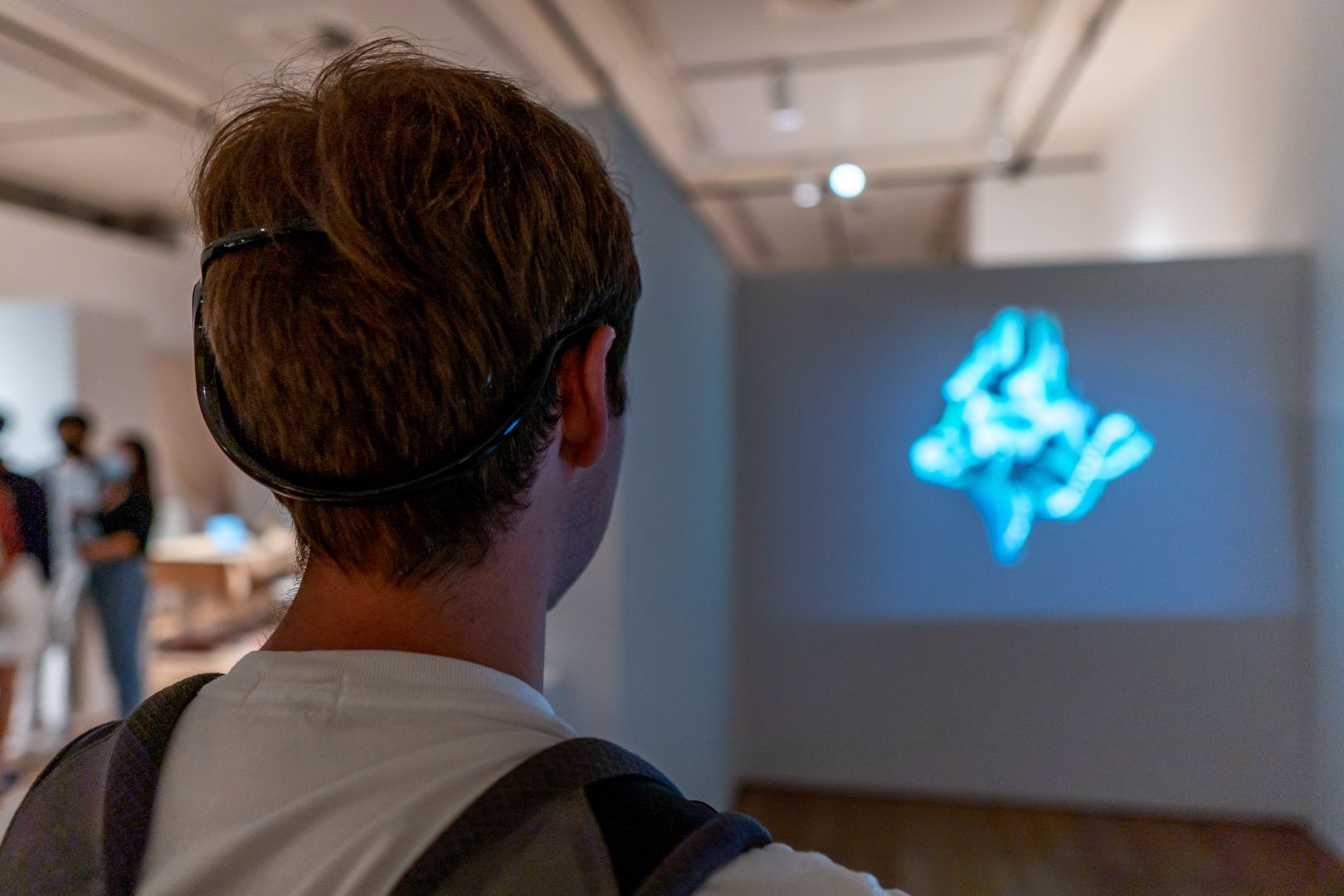 Visitor interfacing with the Encephaloprints exhibition via EEG headband.