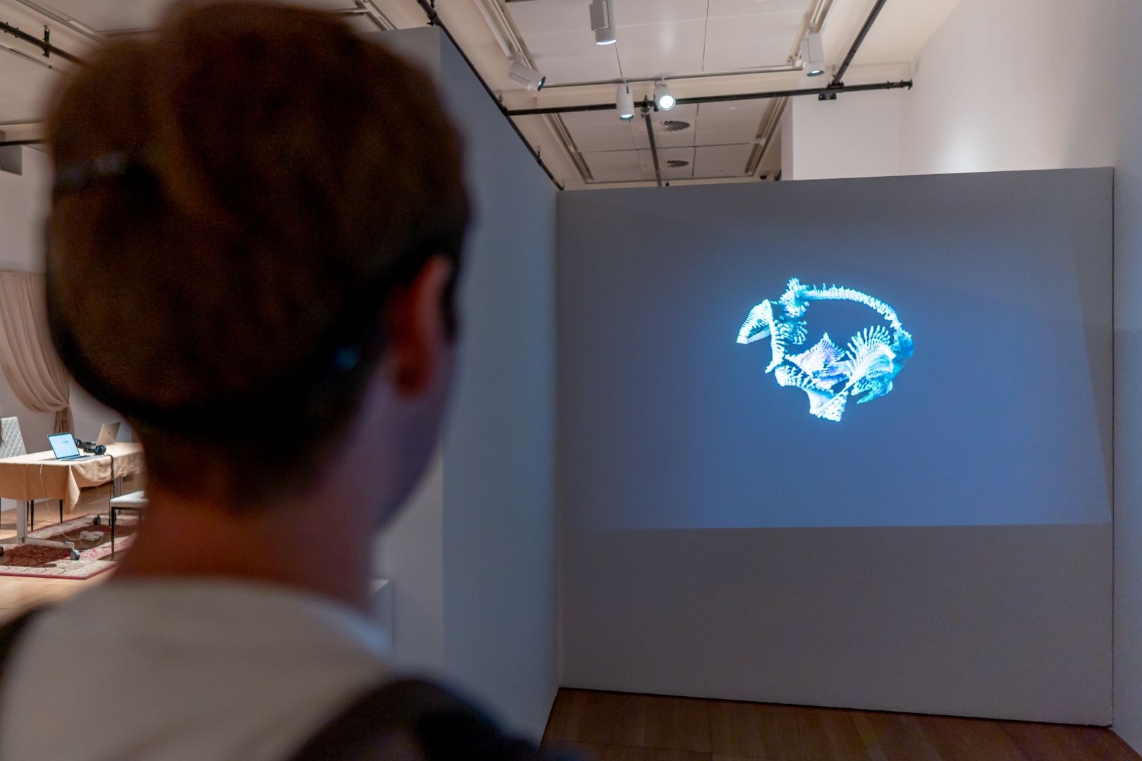 Visitor interfacing with the Encephaloprints exhibition via EEG headband.